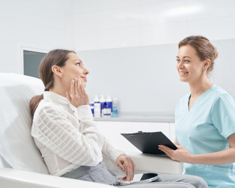 Health professional discussing a skin concern with a patient in a clinical setting